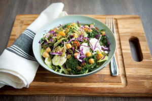 Relatives salad in a bowl on a chopping board with a tablecloth