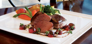 Elk Steak with Sour Cherry Wild Mushroom Sauce, Truffle Potato Pave, Roasted Beets, and Savoy Cabbage