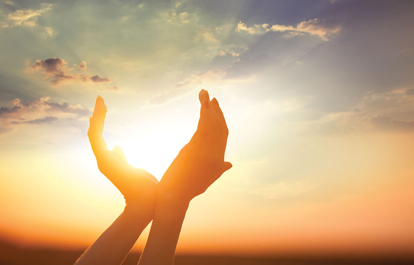 Sunscreened hands enjoy playing with the sun's rays outside