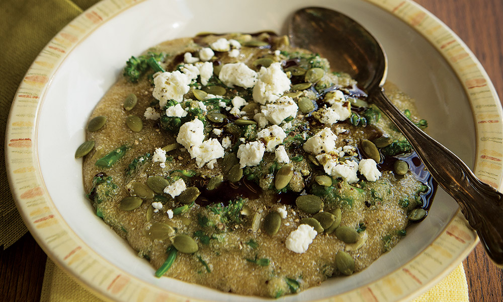 4 cups (1 L) no salt added or low-sodium vegetable stock 1 1/3 cups (330 mL) amaranth 1/3 cup (80 mL) raw, unsalted pumpkin seeds, plus more for serving 1/2 bunch rapini (broccoli rabe), cut into bite-sized pieces 1 Tbsp (15 mL) lemon juice 3 1/2 oz (100 g) goat cheese, crumbled 1 Tbsp (15 mL) pumpkin seed oil or extra-virgin olive oil