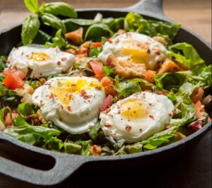Warm Swiss Chard and Tomato Skillet Salad with Poached Eggs and Croutons