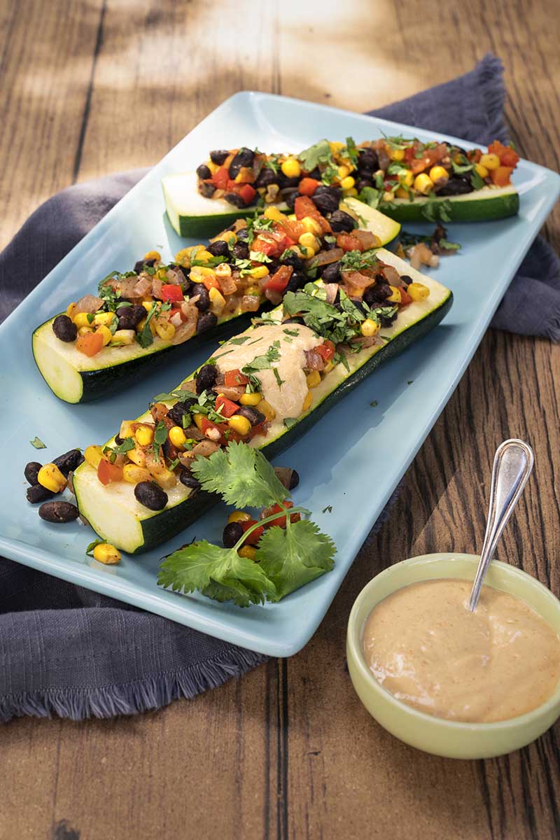 Bean Stuffed Zucchini with Cheesy Sauce