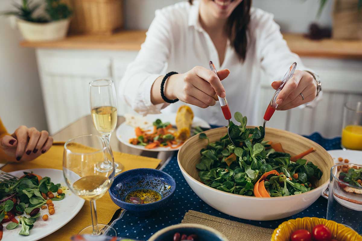 family sits at the dining table and having dinner party at home.