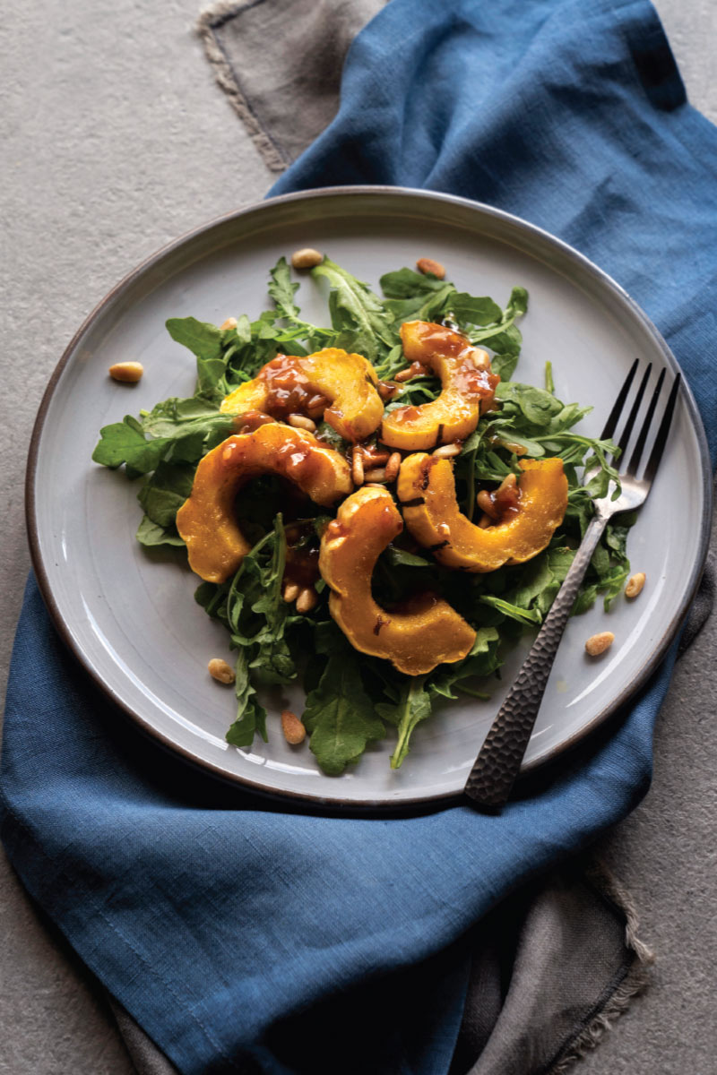 Arugula Salad with Roasted Delicata Squash, Pomegranate Molasses, and Pine Nuts
