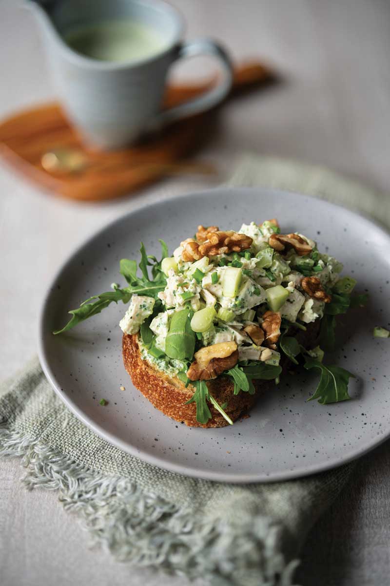 Chicken salad sandwich with peppery arugula dressing